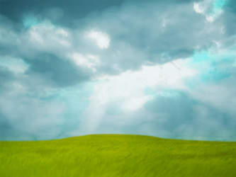 Worship background with green grass and sun rays coming out of a cloudy sky