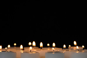 Many burning candles as background photo